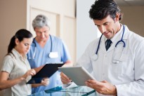 Male Doctor Holding Digital Tablet