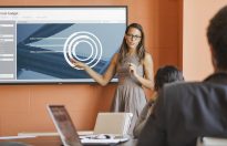 Businesswoman Presenting Budget Chart on Dell 70 Conference Room