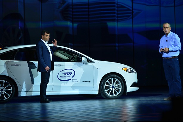 Professor Amnon Shashua (left), senior vice president of Intel and CEO/CTO of Mobileye, arrives on stage in the backseat of an autonomouos car during Intel's preshow keynote at the 2018 Consumer Electronics Show (CES) on Monday, Jan. 8, 2018, in Las Vegas. Shashua joined Brian Krzanich, Intel Corporation chief executive officer, during the keynote. Intel displays how the power of data is affecting our daily lives at the event, which runs Jan. 9-12. <a href=